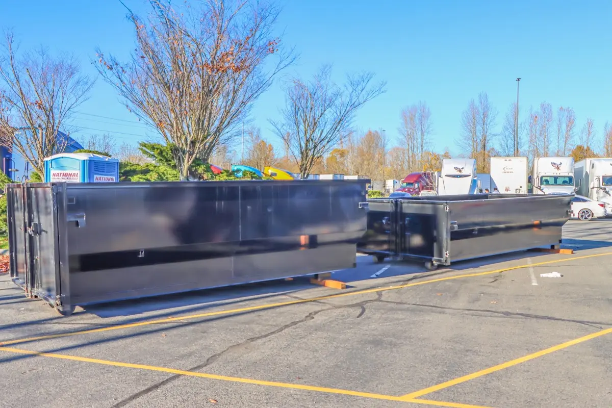 Professional dumpster rental service with roll-off container on residential driveway in Moline